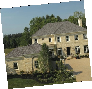 Beautiful brick home with gray shingle roofing