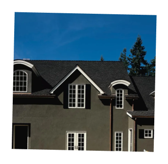 Elegant house with dark roofing and white trim details.
