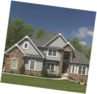 Large home with a mix of stone and gray siding exterior.
