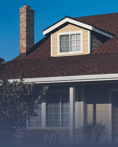 Roof with chimney and window on a house exterior.