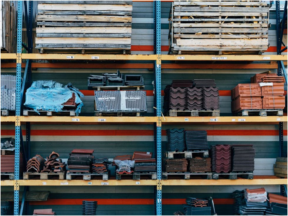 Warehouse shelves stocked with roofing materials and tiles