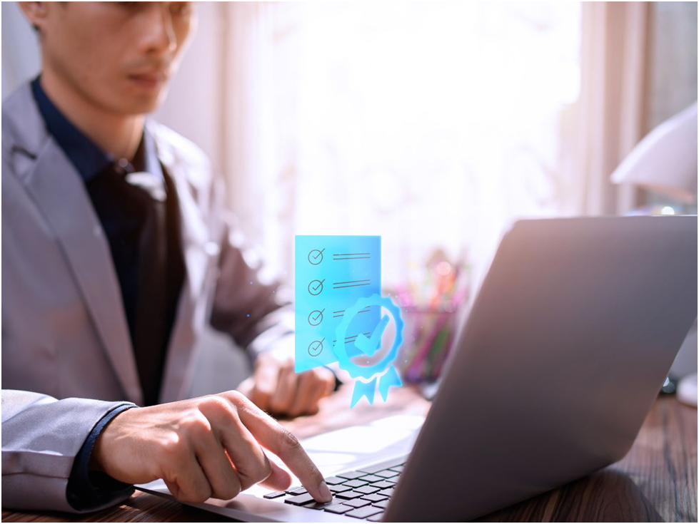 Man using laptop with digital checklist and badge icon