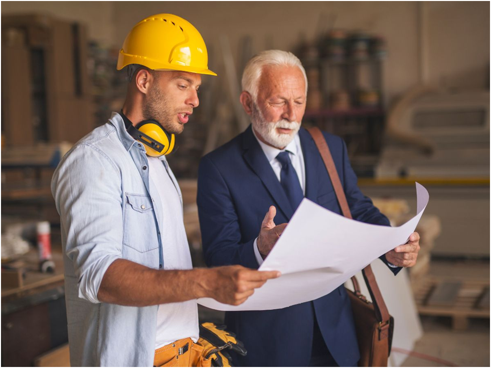 Contractor and architect reviewing building plans
