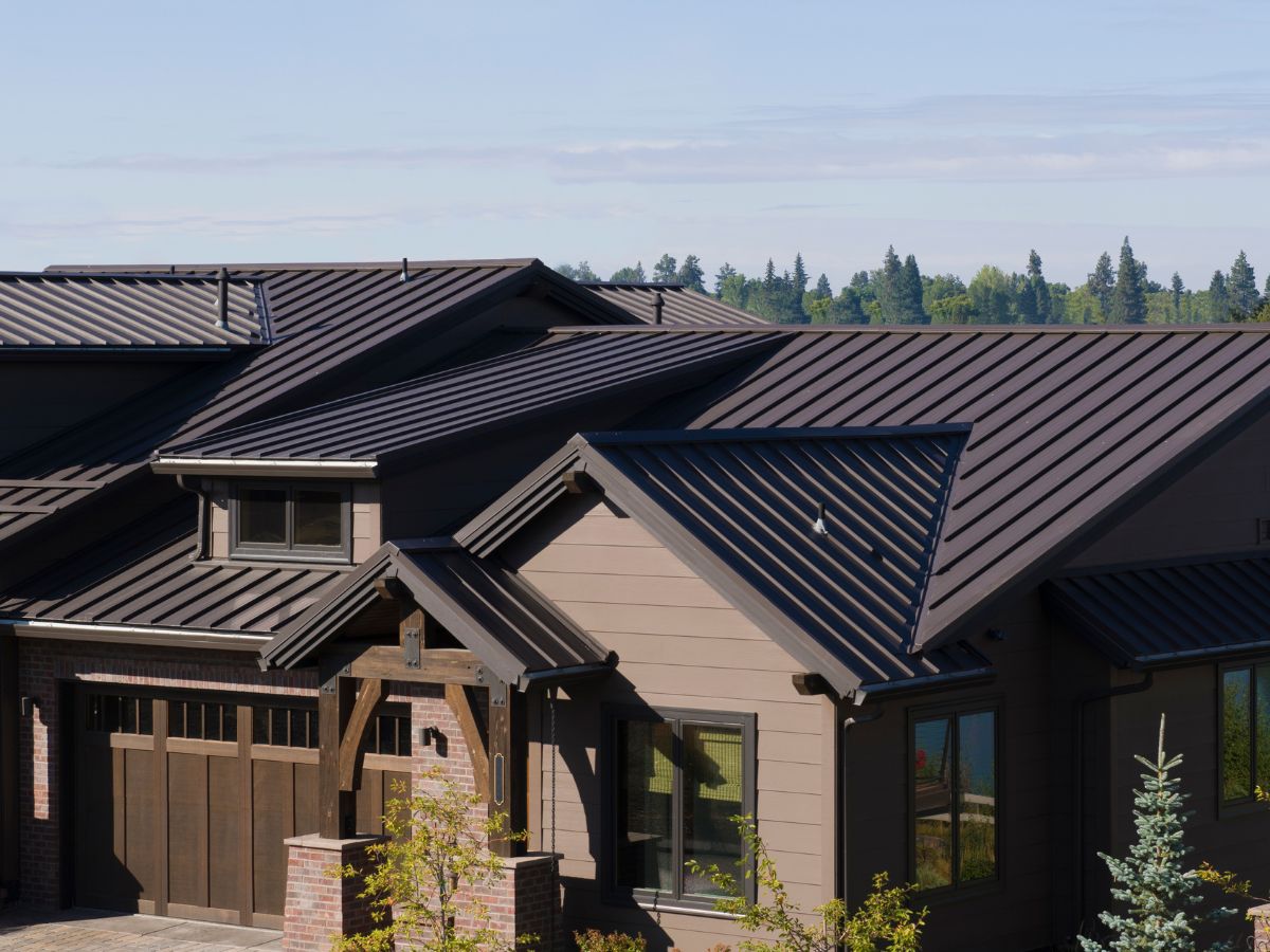 Modern home with dark brown metal roofing panels